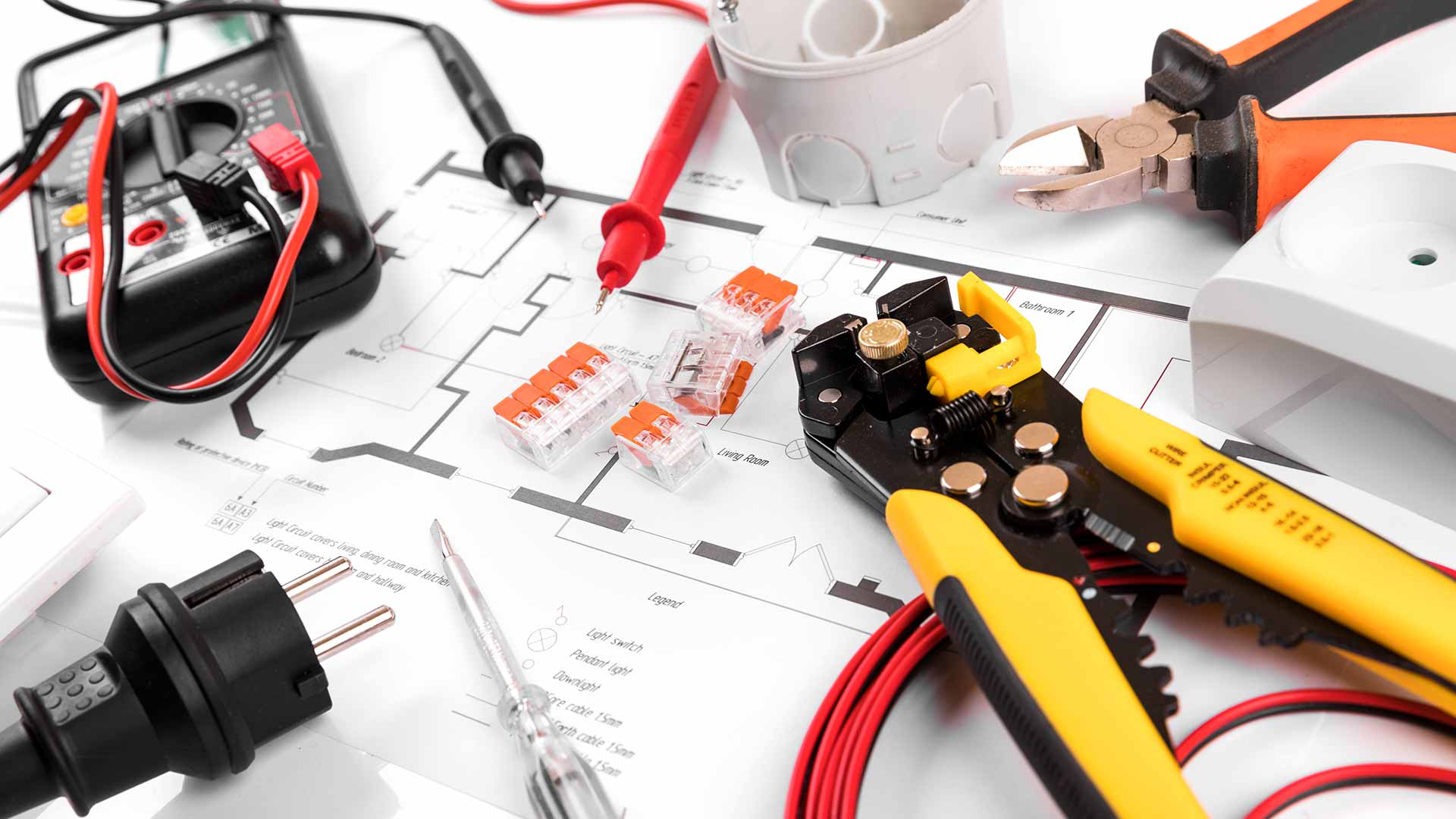 electricians tools and equipment sitting on building plans